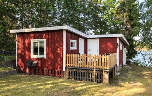 a red tiny house with a wooden porch at 2 Bedroom Cozy Home In Västervik in Västervik