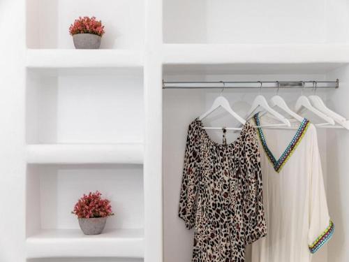 a white closet with a leopard print shirt and a dress at Superb Naxos Apartment Grand Suite In The Heart Of Town Balcony City Views Saint George in Naxos Chora