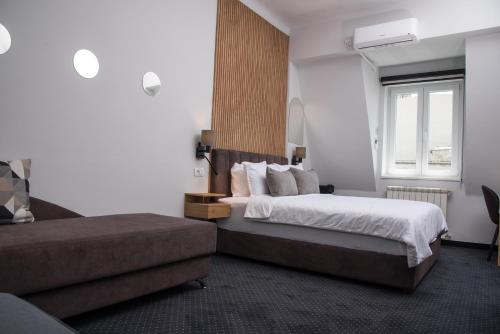 Habitación de hotel con 2 camas y ventana en Republic Square Luxury Suites, en Belgrado