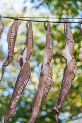 a bunch of carrots hanging from a string at Superb Naxos Apartment Grand Suite In The Heart Of Town Balcony City Views Saint George in Naxos Chora