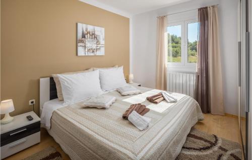 a bedroom with a bed with towels on it at 3 Bedroom Gorgeous Home In Labin in Labin