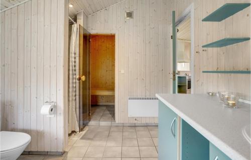 a bathroom with a sink and a toilet in a room at Holiday Home Strandparken Xi in Otterup