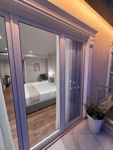 a view of a bedroom with a bed through a window at Bizant Boutique Hotel & Coffee,Bar in Durrës
