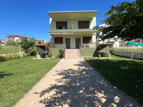 a house with a pathway leading up to it at Ioannis Villa in Nea Fokea