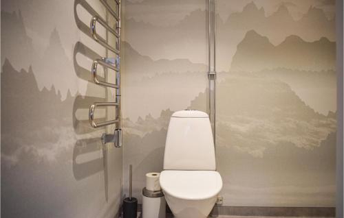a bathroom with a toilet with mountains on the wall at Gorgeous Home In Borgholm With Wifi in Borgholm