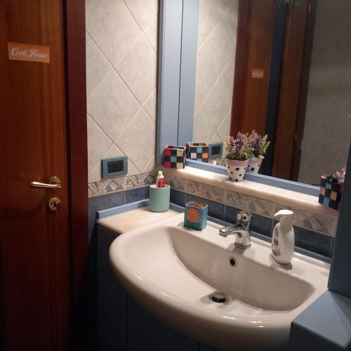 a bathroom with a sink and a mirror at Conti House in Salerno