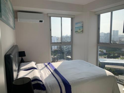 a bedroom with a bed with a view of a city at Connect in Lima