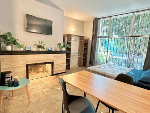 a living room with a table and a fireplace at Casa Isolda in Mexico City