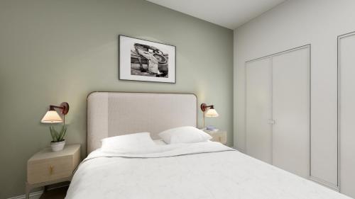 a bedroom with a white bed with two night stands and two lamps at Locale Fort Worth in Fort Worth