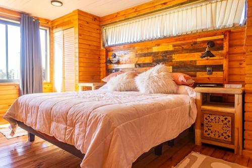 a bedroom with a bed with two animals laying on it at PEZ HOUSE in Pichilemu