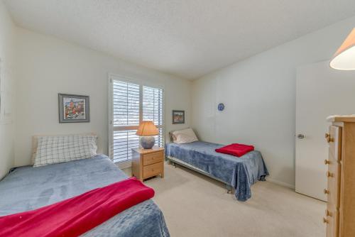 a bedroom with two beds and a window at Alto Townhome with Deck Near Ski Apache! in Alto