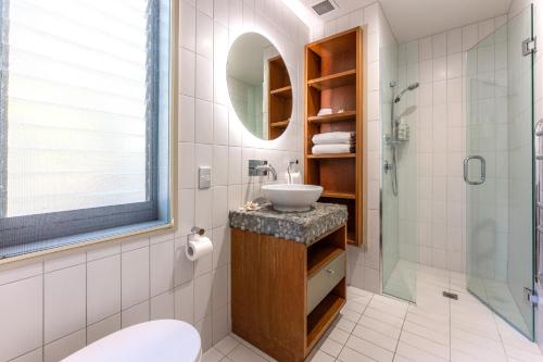 a bathroom with a sink and a shower at The Sands - Apartment 19 in Onetangi
