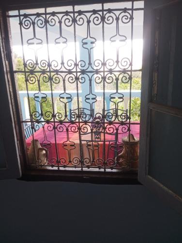 a door with a window with a view of a patio at Dar Lala Zhour in Aïn Bouchrik