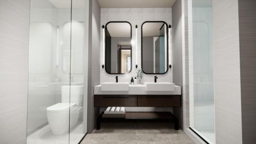 a bathroom with a sink and a toilet and mirrors at Black Desert Resort in Ivins