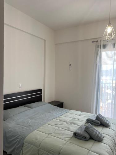 a bedroom with a bed with two towels on it at Reis Villa in Nikiana