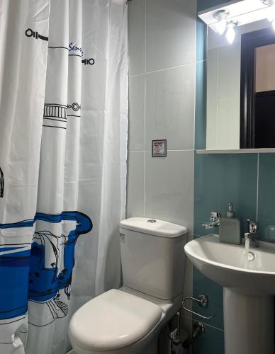 a bathroom with a toilet and a sink at Reis Villa in Nikiana