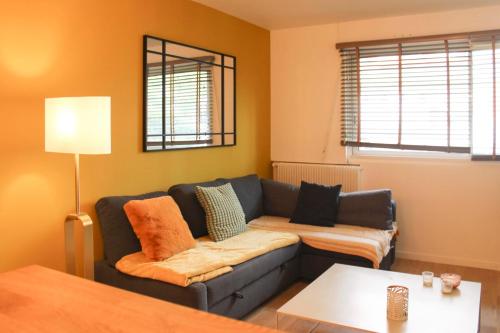 un salon avec un canapé et une table dans l'établissement Cosy apartment at the gates of Paris, à Montreuil