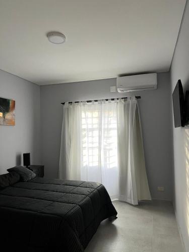 a bedroom with a bed and a window at Departamentos Oliver in Santa Rosa