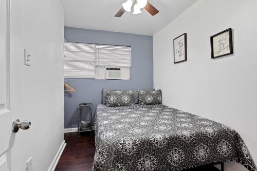 a bedroom with a bed and a ceiling fan at Pao and Pui in Kenner