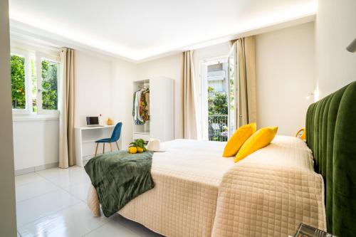 a bedroom with a large bed with yellow pillows at Villa Talia in Sorrento