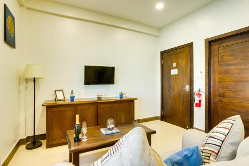 a living room with a couch and a table at Louis' Apartments in Placencia Village