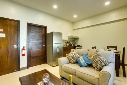 a living room with a couch and a kitchen at Louis' Apartments in Placencia Village