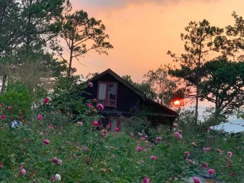 a house in the middle of a field of flowers at Romantic house 2 on a pine hill Dalat in Da Lat