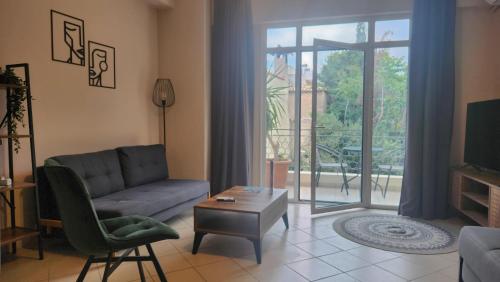 a living room with a couch and a table at Boutique Studios & Apartments - by Avelink in Spáta