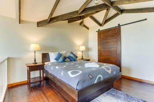 a bedroom with a large bed and wooden floors at Louis' Apartments in Placencia Village