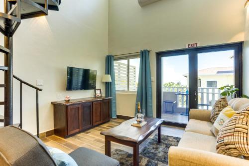 a living room with a couch and a tv at Louis' Apartments in Placencia Village