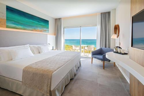 a bedroom with a bed and a view of the ocean at Barceló Conil Playa - Adults Recommended in Conil de la Frontera