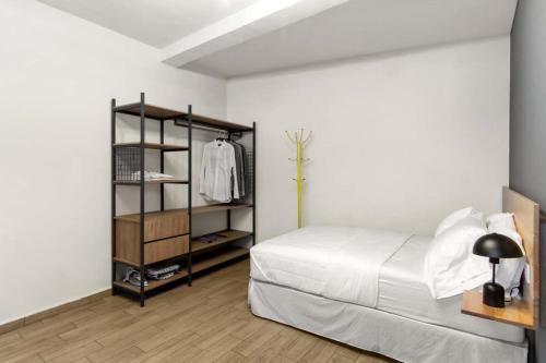 a bedroom with a bed and a book shelf at MS Moderna Suite Arcos Hercules HD1 in Laborcillas