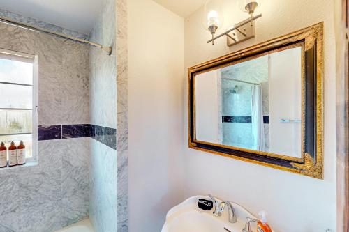 a bathroom with a mirror and a sink at Vineyard Estate in Cotati