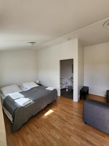 a bedroom with a large bed and a couch at Fjós Guesthouse in Varmahlid