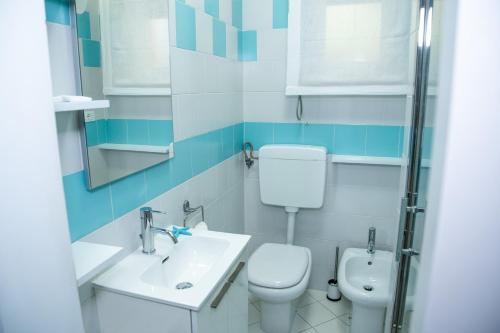 a bathroom with a toilet and a sink at DiBa House 46 in San Vito Chietino