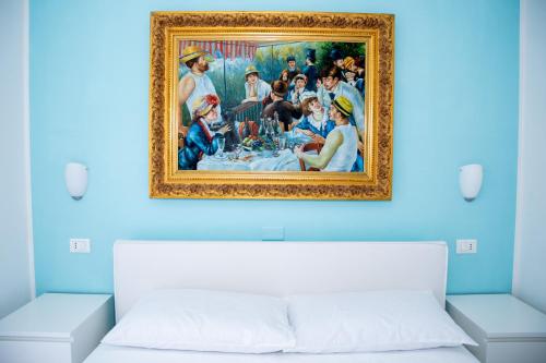 a painting above a bed in a room at DiBa House 46 in San Vito Chietino
