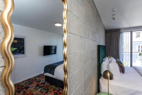 a bedroom with a large mirror next to a bed at Arluxia in Auckland
