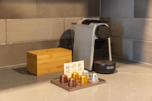 a kitchen counter with a air conditioner and a box at Arluxia in Auckland