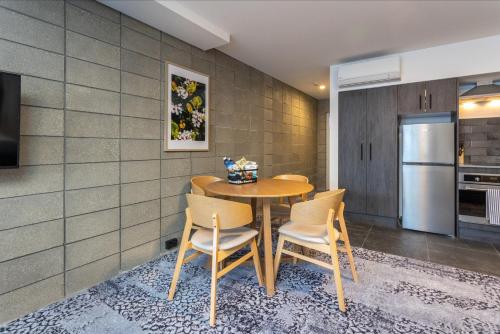 a dining room with a table and chairs at Arluxia in Auckland