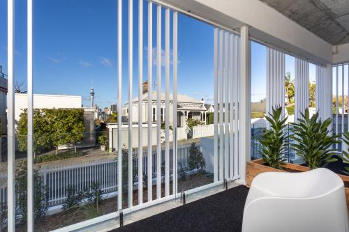 a view from the balcony of a building with large windows at Arluxia in Auckland