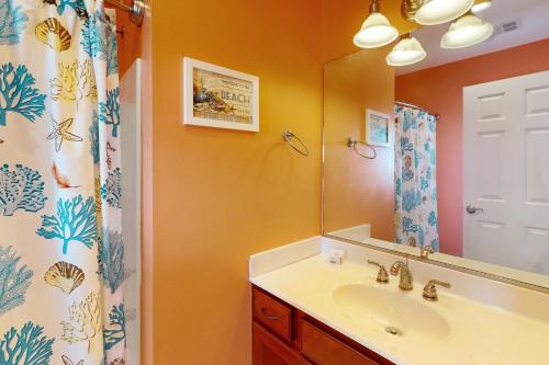 a bathroom with a sink and a mirror at Sunrise Paradise in Hatteras