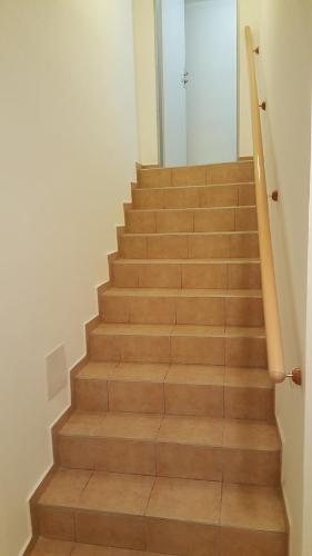a staircase with wooden steps with a glass door at Penzion Sofi in Prague