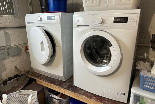 a washing machine and a washer on a counter at House in Hlíðarvegur, Kópavogur - Birta Rentals in Reykjavík