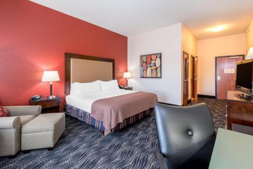 a hotel room with a large bed and a chair at Holiday Inn Express & Suites Casa Grande, an IHG Hotel in Casa Grande