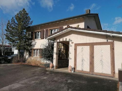 a large white building with a garage at Budget Chalet at Lucerne City! in Luzern