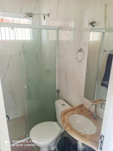 a bathroom with a toilet and a sink and a shower at Casa PHB in Parnaíba