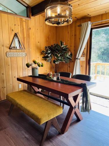 a dining room with a wooden table and a potted plant at Perch - Ellie's Secret Cabin in Coupeville