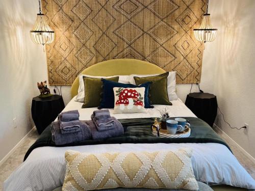 a bedroom with a large bed with two towels on it at Perch - Ellie's Secret Cabin in Coupeville
