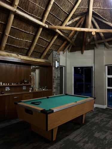 a pool table in the middle of a room at STAY In TEHAMA in Cape Town