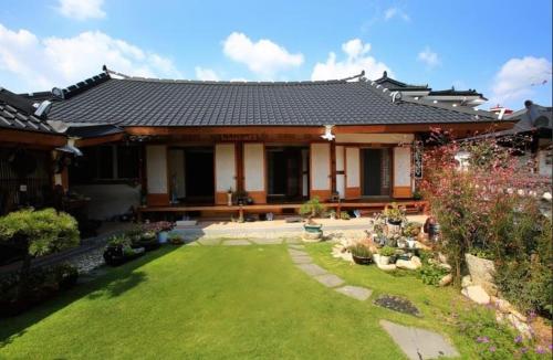 a house with a garden in front of it at Hanok Madang in Jeonju